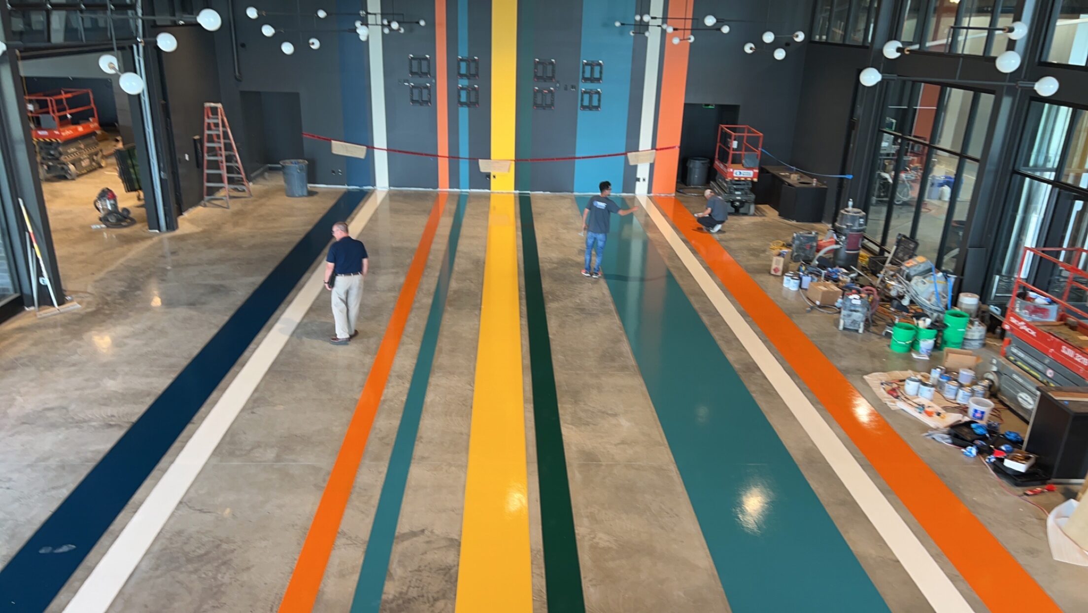 Polished concrete floor with custom colored lanes in a commercial space
