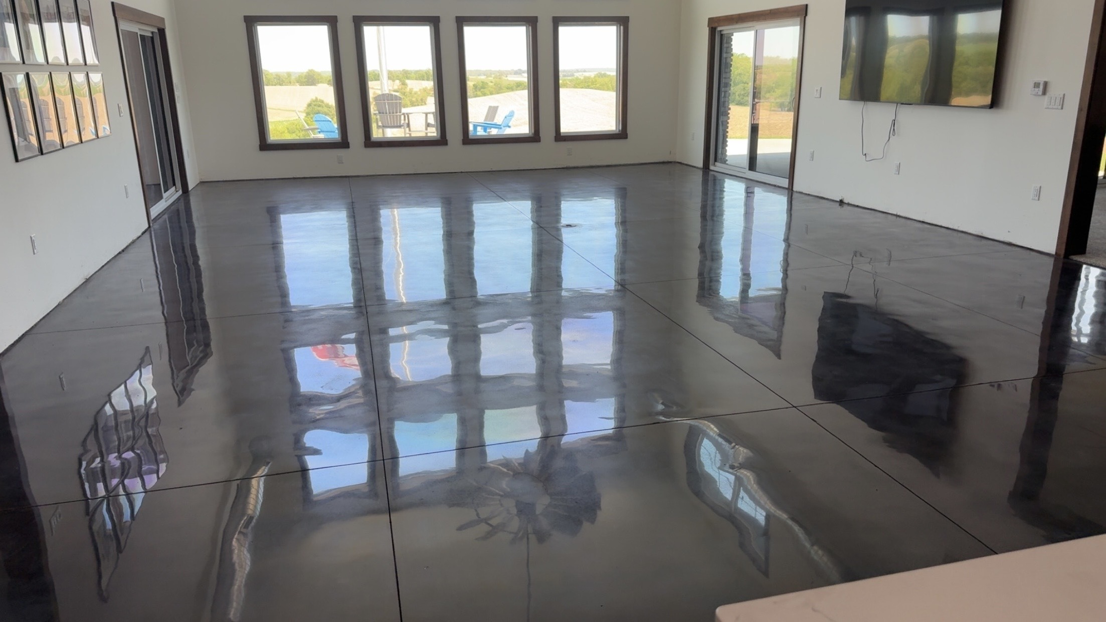 High-gloss finished concrete floor reflecting the windows